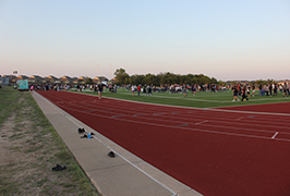  A football field and track full of people